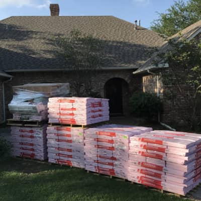 Roofing supplies ready to go up on a job site in Denton!